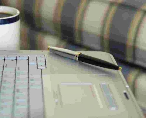 laptop with pen for mortgage planning