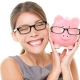 lady smiling with savings of home loan interests in piggy bank