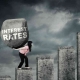 homeowner with stone on back: bearing weight of rising interest rate
