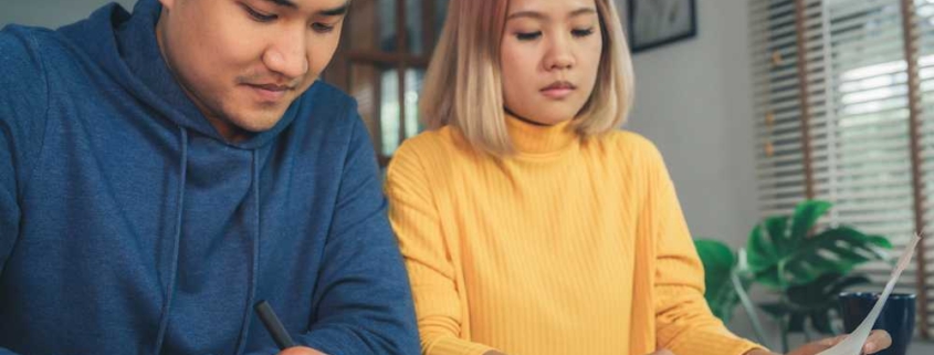 couple calculating mortgage interest costs